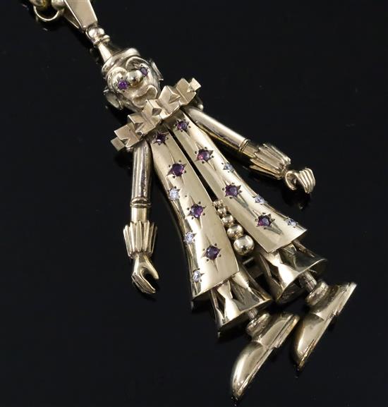 A 1960s 9ct gold and gem set pendant modelled as a clown, on a 9k gold round and elongated link chain, pendant 78mm.
